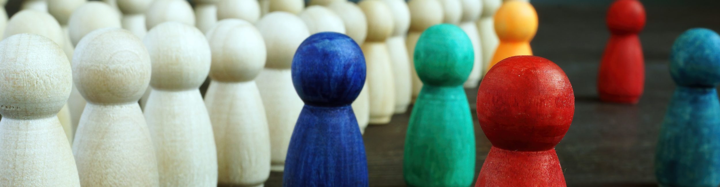A group of wooden figures in various colours