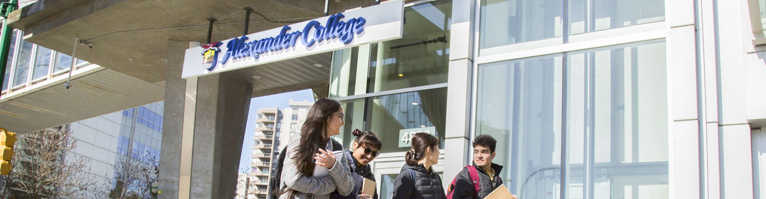 A group of Alexander College students walking outside Burnaby campus