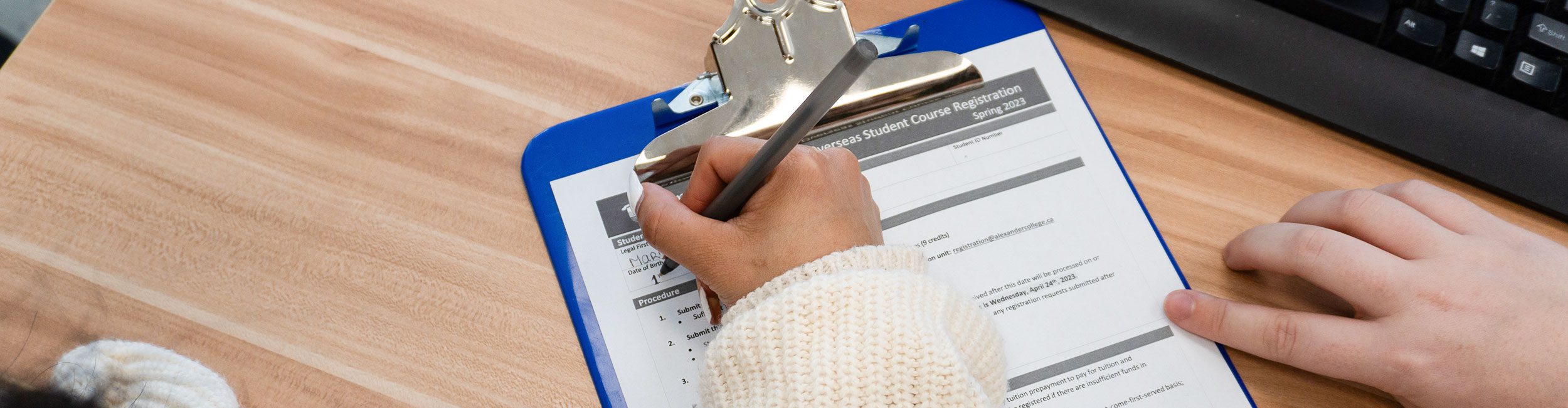 A close up shot of a student filling out a form