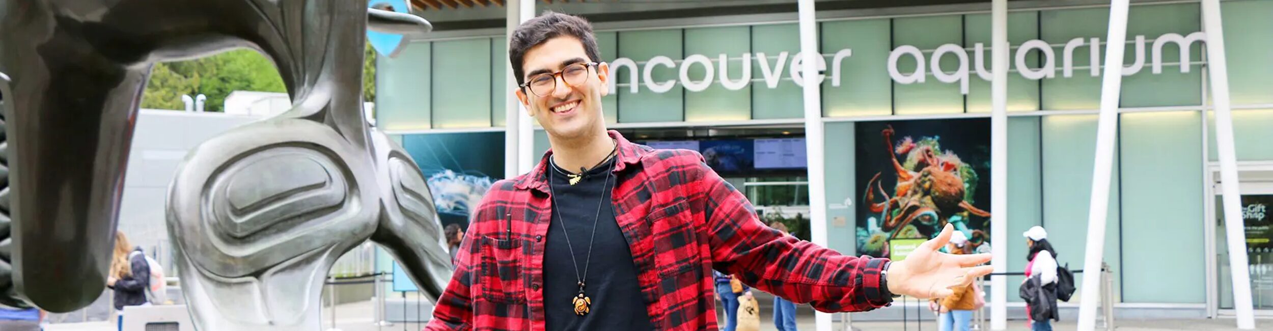 Alexander College Student Gabriel poses in front of the Vancouver Aquarium